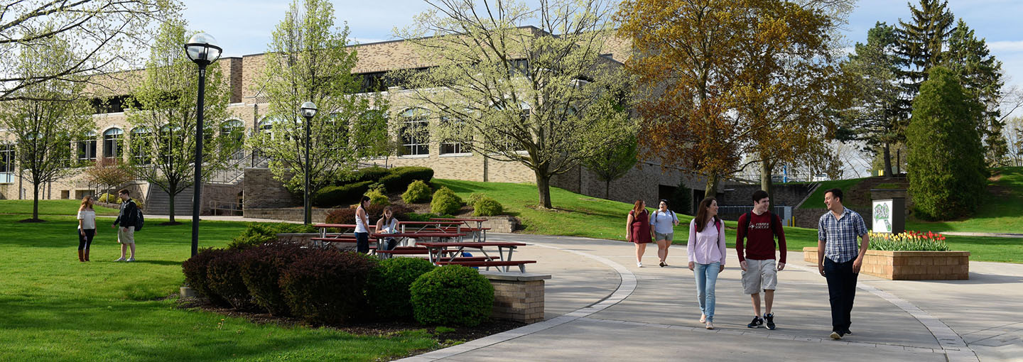 Three students walk through LeChase Commons on the Fisher campus.