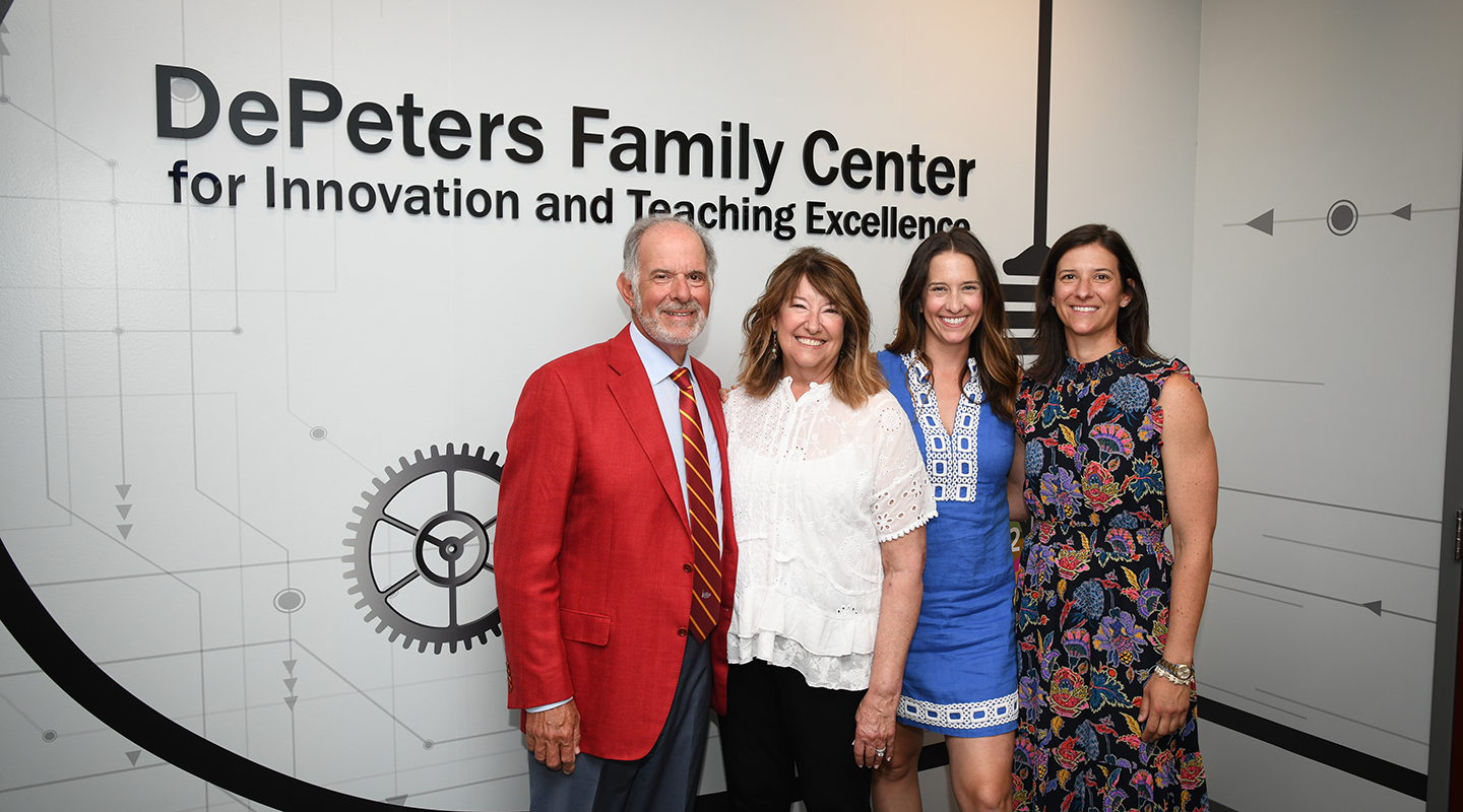 The DePeters Family stands in front of the DePeters Family Center for Innovation and Teaching Excellence