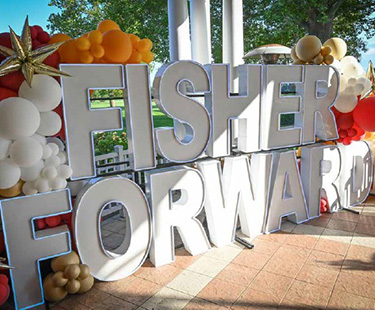Fisher Forward sign with balloons.