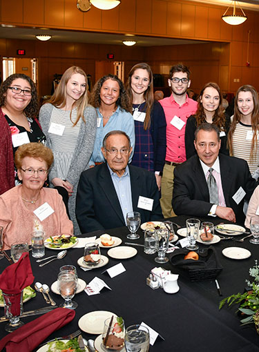 A group of students gathered around Elaine and Charlie Constantino.