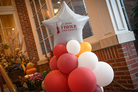 A decorative tower made of red and white balloons, arranged in a vibrant and eye-catching formation.