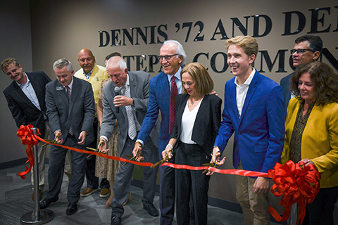 Dennis and Denise Tepas join the Fisher community in cutting a ribbon at the unveiling of the Tepas Commons.