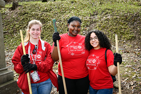 Three Fisher students volunteer to rake in Mount Hope Cemetery. 