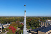 Aerial of the Kearney Hall steeple against a blue sky.