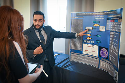A student presents their work during a research symposium